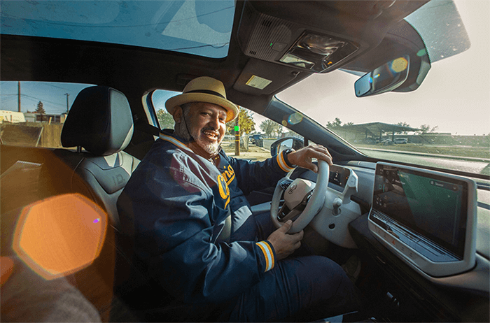 Huron Mayor Rey León smiles as he drives on the Green Raiteros electric vehicles